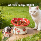 White cat sitting beside a ceramic mushroom‑design slow feeder bowl with inset image showing a cat eating to highlight whisker‑friendly relief.
