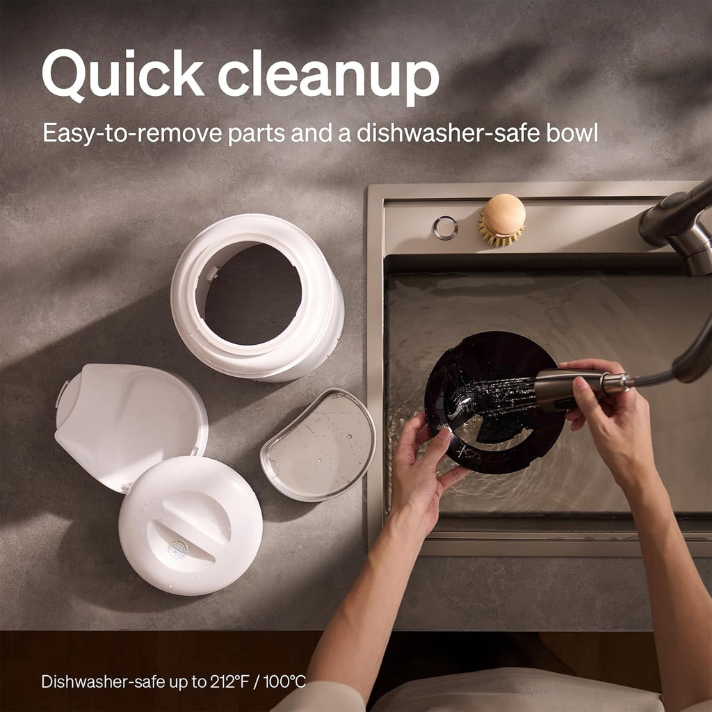 Dishwasher‑safe pet feeder parts being washed in a kitchen sink, showing quick cleanup with removable components.