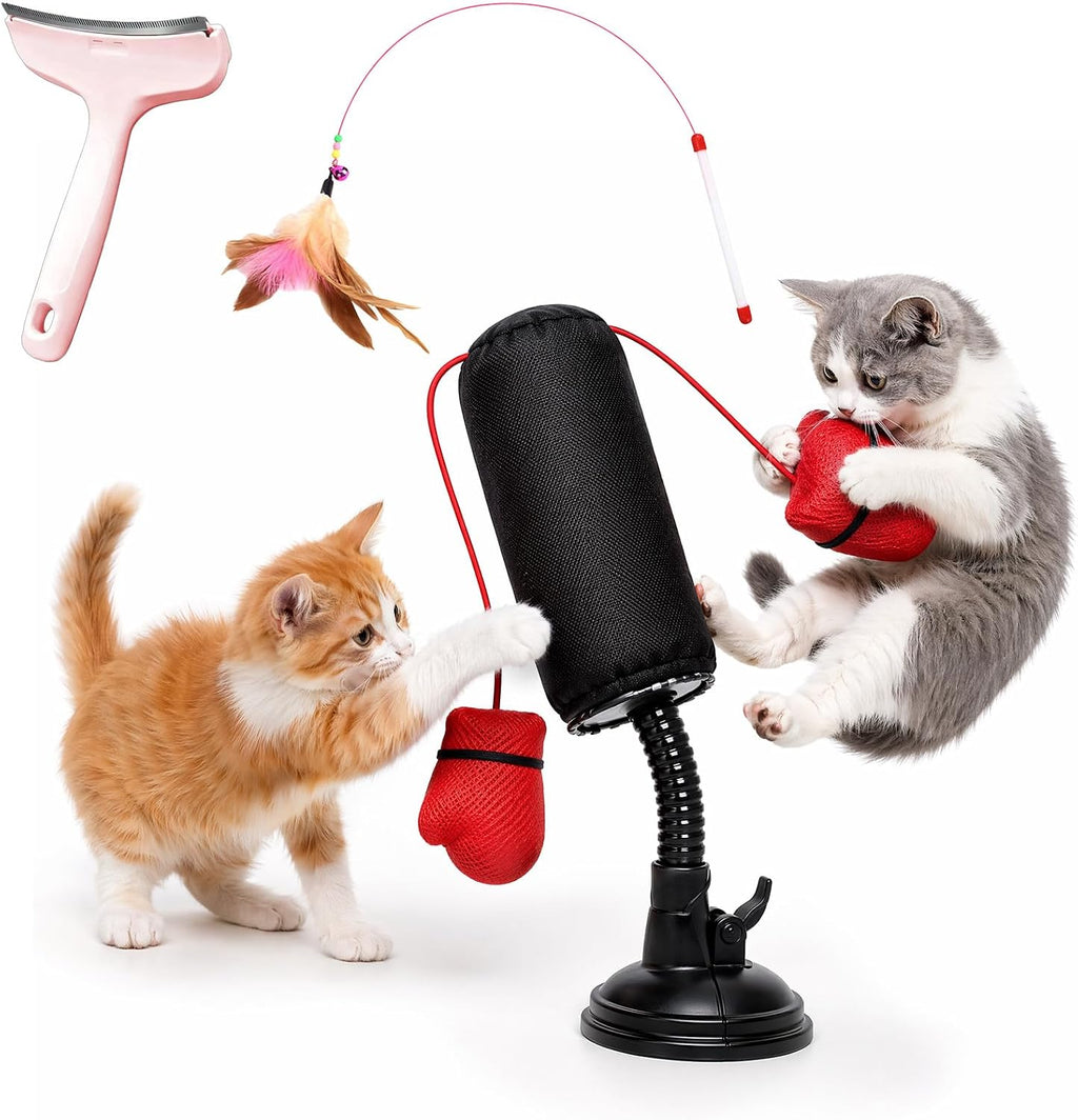 Two cats playing with an interactive cat boxing bag toy featuring a flexible stand, suction cup base, and dangling red boxing gloves.