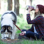 dog drinking from removable bowl while owner holds 37oz insulated stainless steel water bottle burgundy