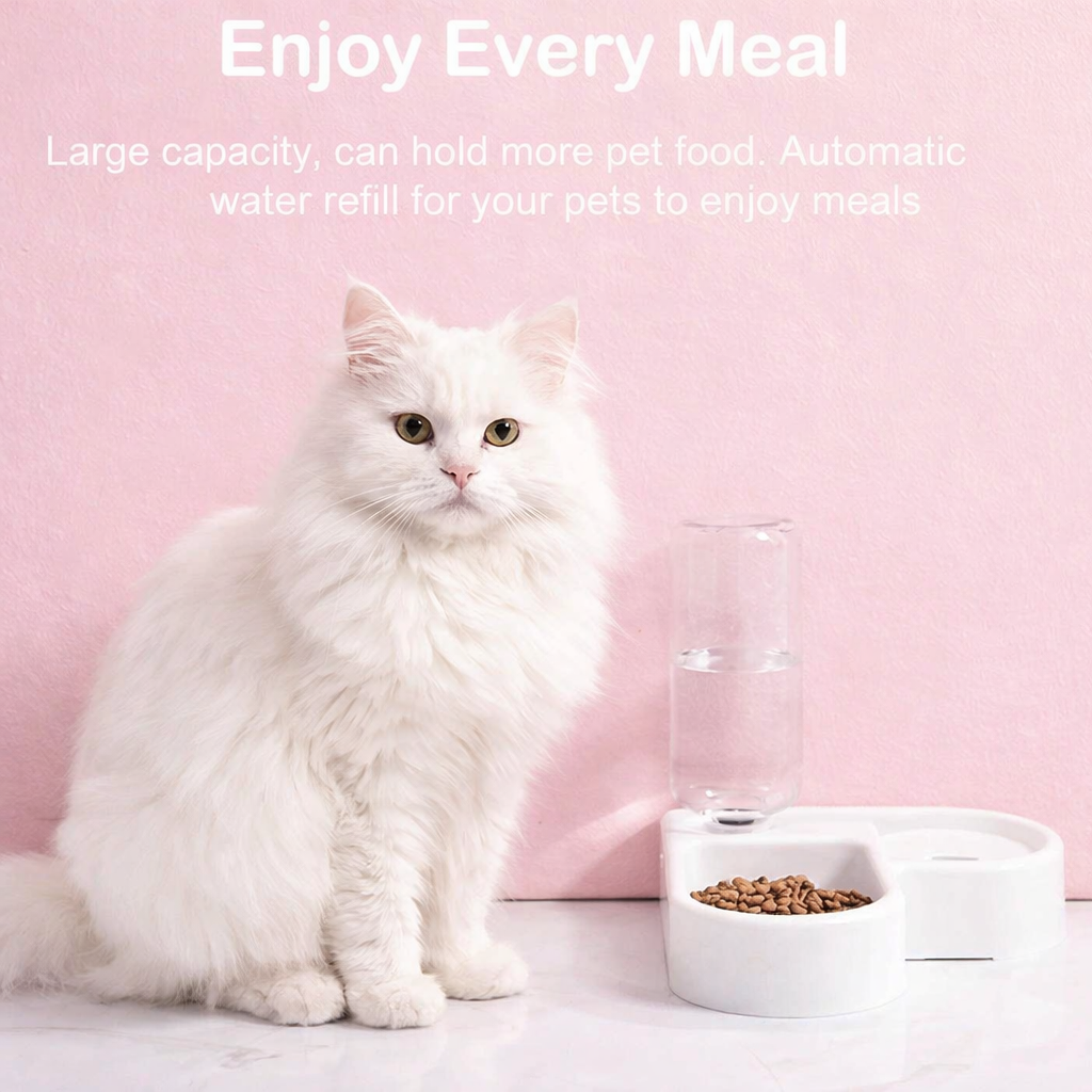 White Angora cat sitting beside an automatic pet feeder with food and water dispenser on a pastel pink background, promoting clean and convenient feeding for cats and dogs.