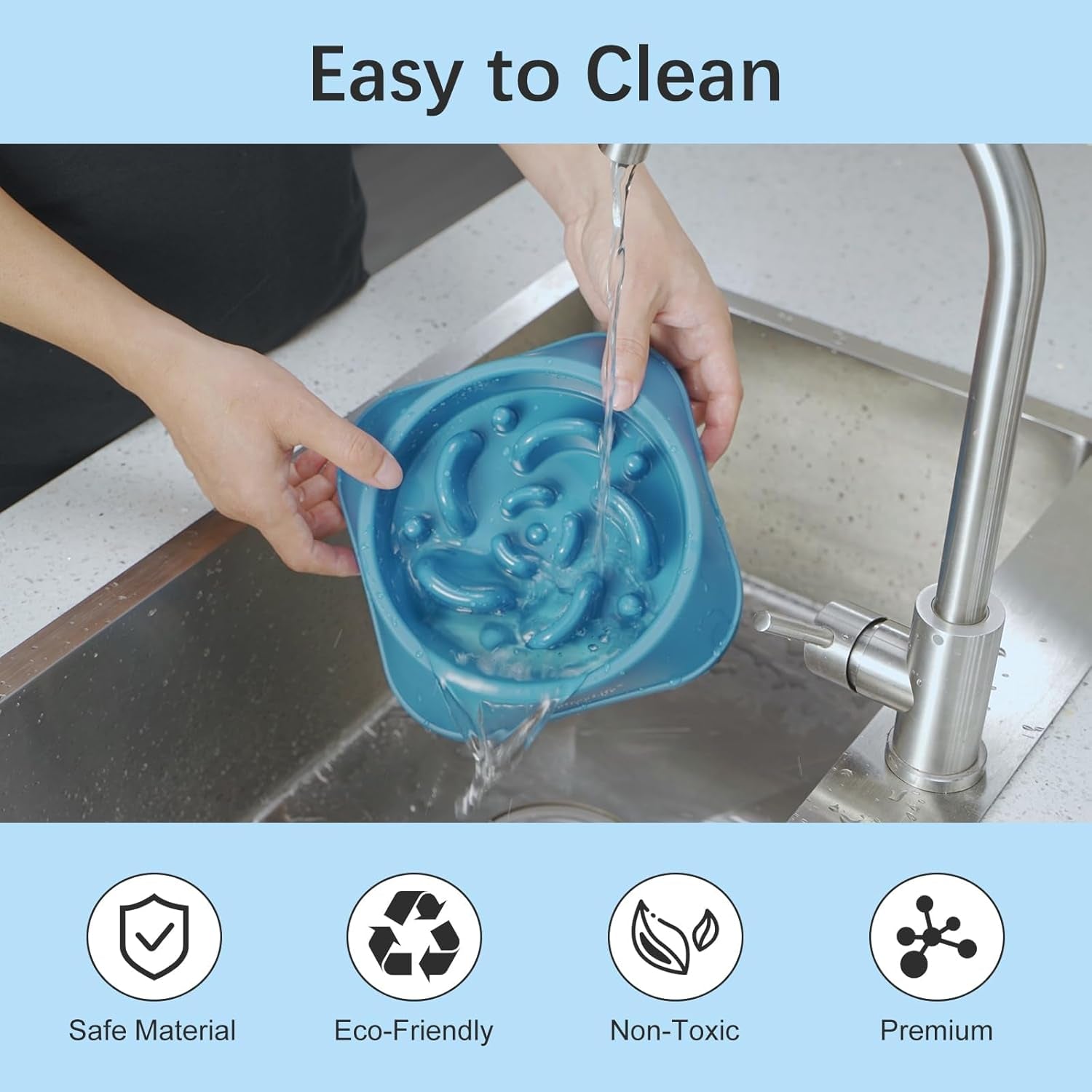 Person washing a blue slow feeder dog bowl with maze design under running water, highlighting easy cleaning, safe material, eco‑friendly and non‑toxic features.
